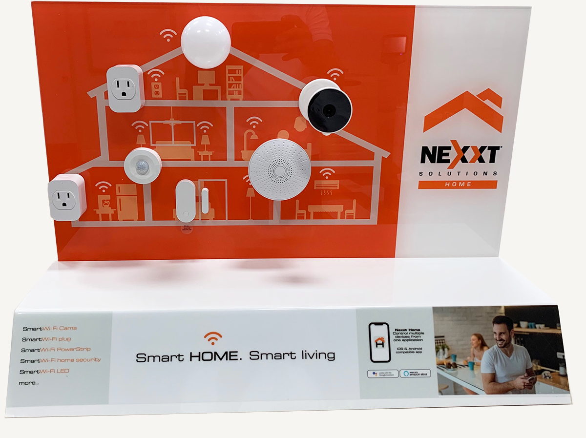 Nexxt Home acrylic display showing smart-home devices on an illustrated house