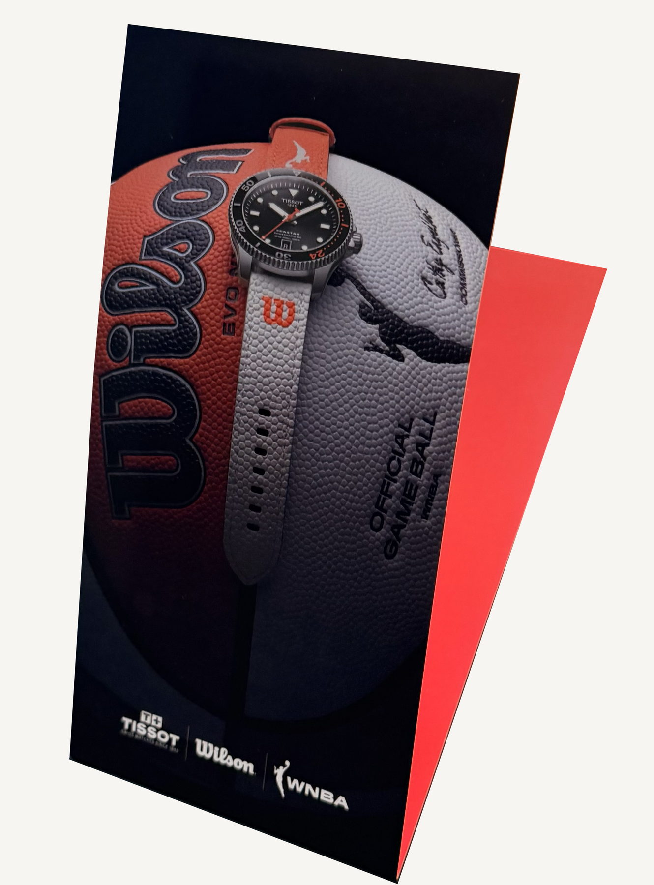 Folded Tissot card showing a watch resting on a basketball
